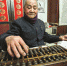 2015年1月31日，95岁的金城一个人负责四家文印店的会计工作。记者 葛亚琪 摄 - 浙江新闻网