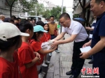青田县委统战部负责人向小华侨们发放相关教材。青统供图 - 浙江新闻网