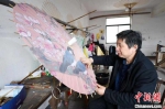 闻士善正在制作油纸伞。受访者供图 - 浙江新闻网