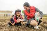 少数民族儿童在青年志愿者带领下体验玉米播种，从小树立保护耕地资源、爱护生态环境的理念。吴拯摄 - 浙江新闻网